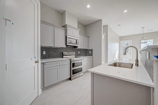 a kitchen with white cabinets and white appliances