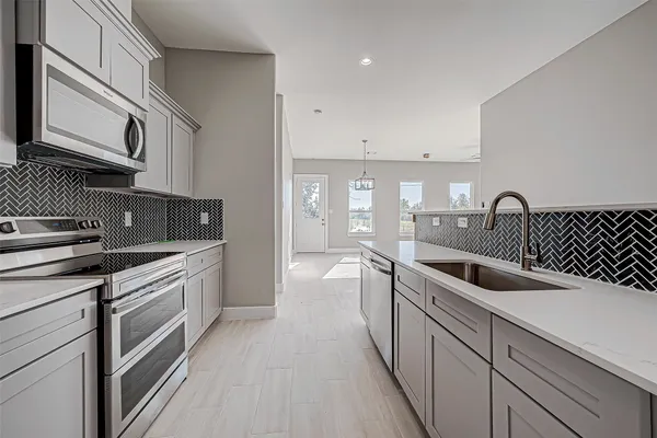 a kitchen with a sink and cabinets