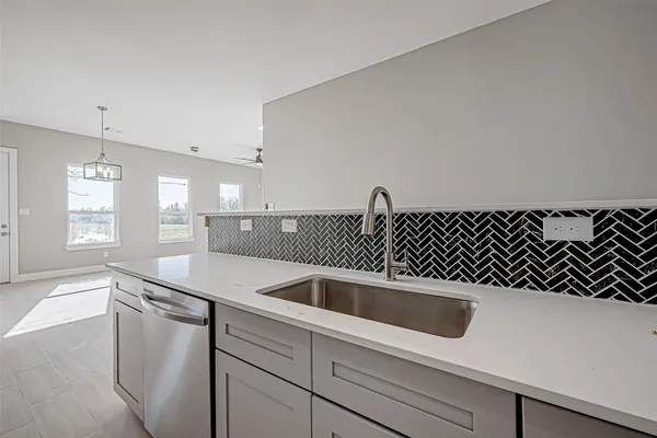 a kitchen with a sink and white cabinets
