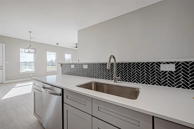 a kitchen with a sink and white cabinets