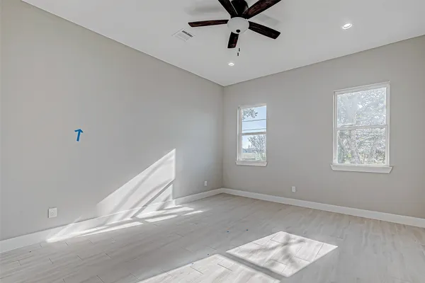 a view of a big room with wooden floor and windows in a room