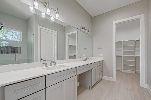 a bathroom with a double vanity sink and a mirror