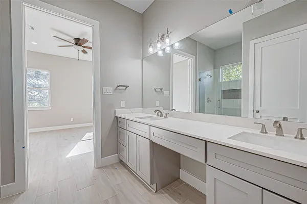a bathroom with a double vanity sink and a mirror