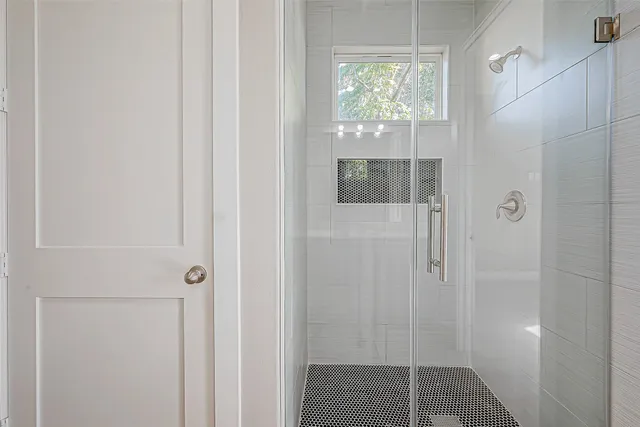 a bathroom with a glass shower door