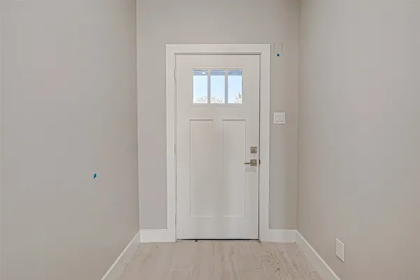 an empty room with wooden floor and closet