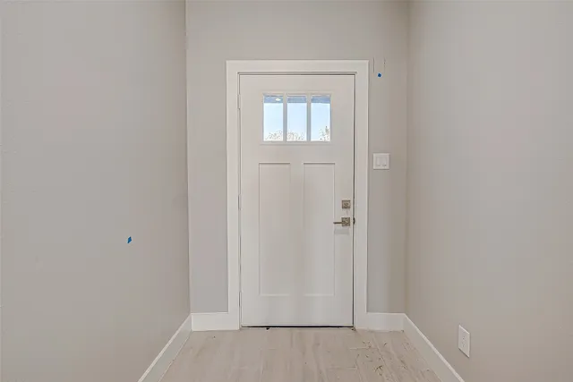 an empty room with wooden floor and closet