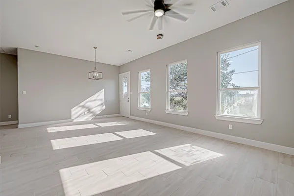 a view of an entryway with wooden floor and a ceiling fan