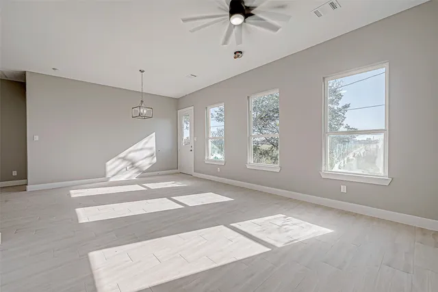 a view of an entryway with wooden floor and a ceiling fan