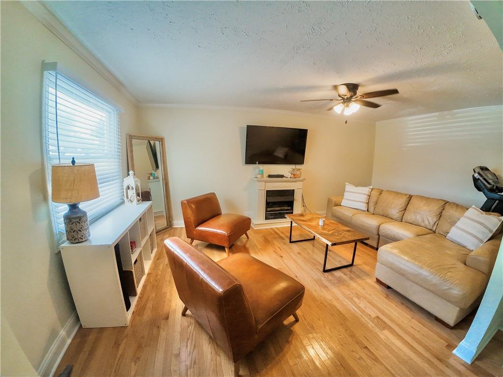 3905 Hunt Drive Gainesville, GA 30507 - Photo 5 of 16 a living room with furniture a ceiling fan a lamp and a flat screen tv