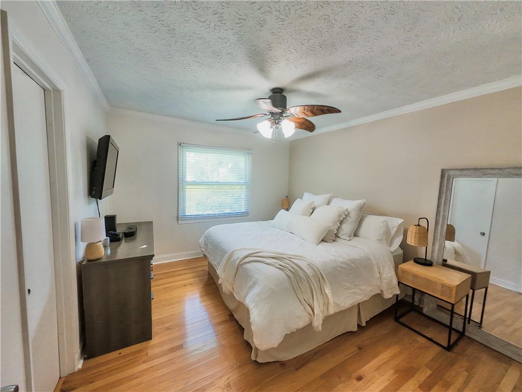 3905 Hunt Drive Gainesville, GA 30507 - Photo 10 of 16 a bedroom with a bed and a flat screen tv