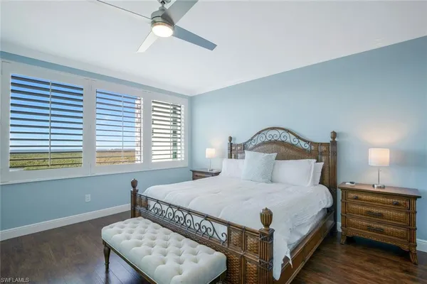 a bedroom with a bed and a night stand