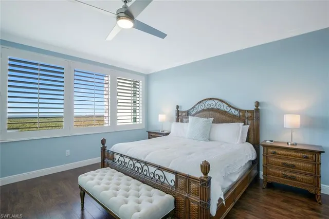 a bedroom with a bed and a night stand