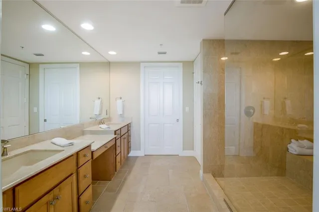 a bathroom with a granite countertop sink a shower and a mirror