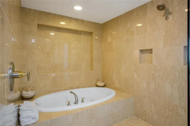 a bathroom with a bathtub and shower