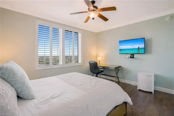 a bedroom with a bed and a desk