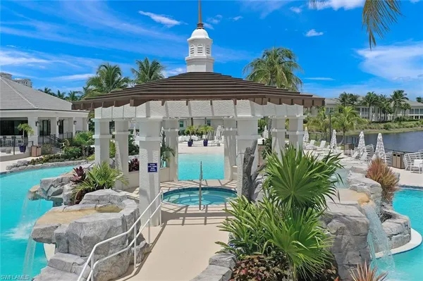 a view of a patio with couches table and chairs with potted plants