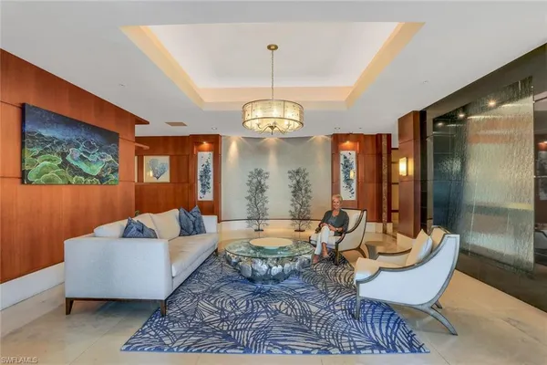 a living room with furniture and a chandelier