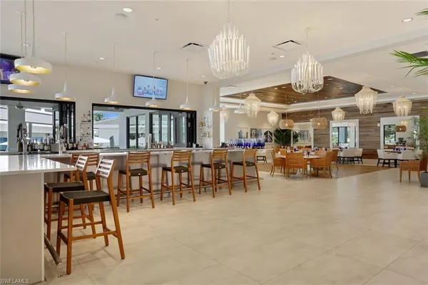a view of a dining room with furniture and a chandelier