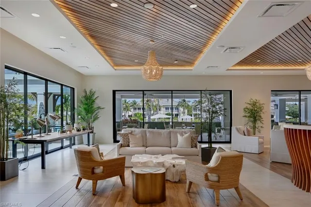 a dining room with furniture and a floor to ceiling window