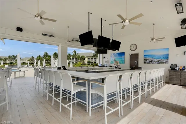 a kitchen with stainless steel appliances kitchen island granite countertop a table chairs and a chandelier