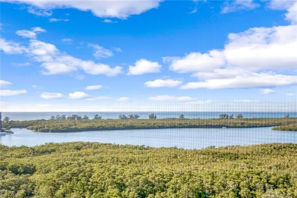 a view of a lake with houses in the background