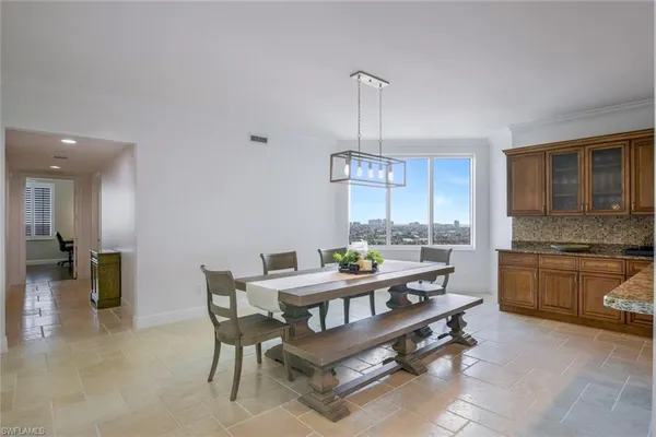 a dining room with furniture and window
