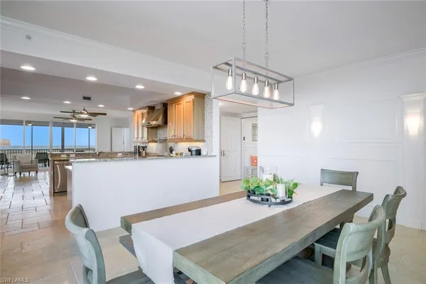 a view of a dining room with furniture and a chandelier