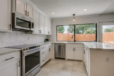 a kitchen with a stove microwave and sink