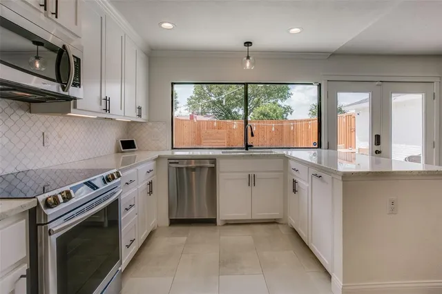 a kitchen with a sink stove and cabinets