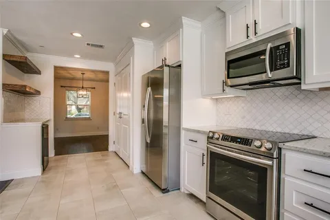 a kitchen with stainless steel appliances a stove a microwave and a refrigerator