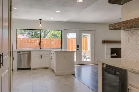 a kitchen with a white stove top oven sink and window