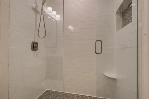 a bathroom that has a glass shower door