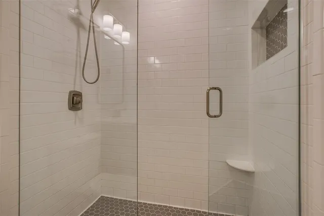 a bathroom that has a glass shower door