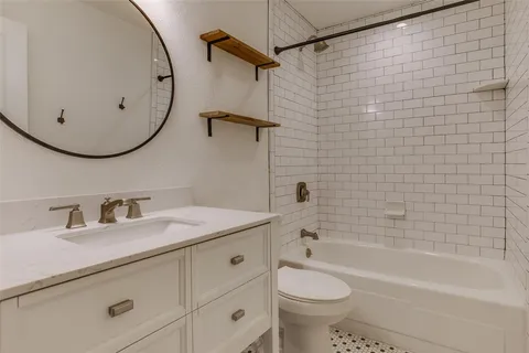 a bathroom with a sink a toilet and bathtub