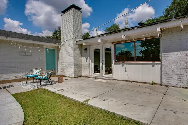 a backyard of a house with outdoor seating