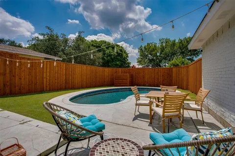 a patio with table and chairs