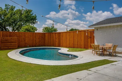 a view of outdoor space with swimming pool and furniture