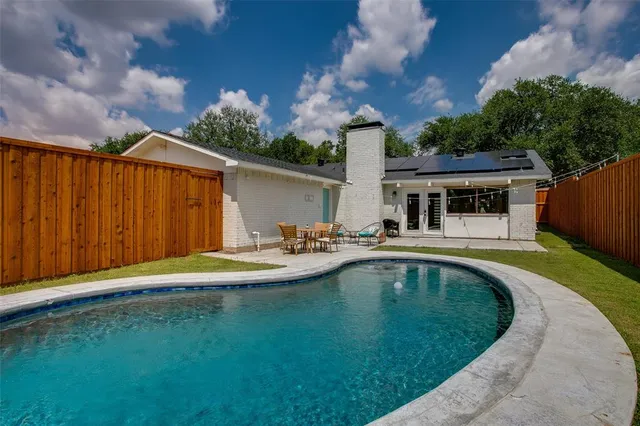 a view of a house with swimming pool and porch