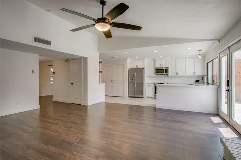 a view of kitchen with stainless steel appliances refrigerator stove microwave and cabinets