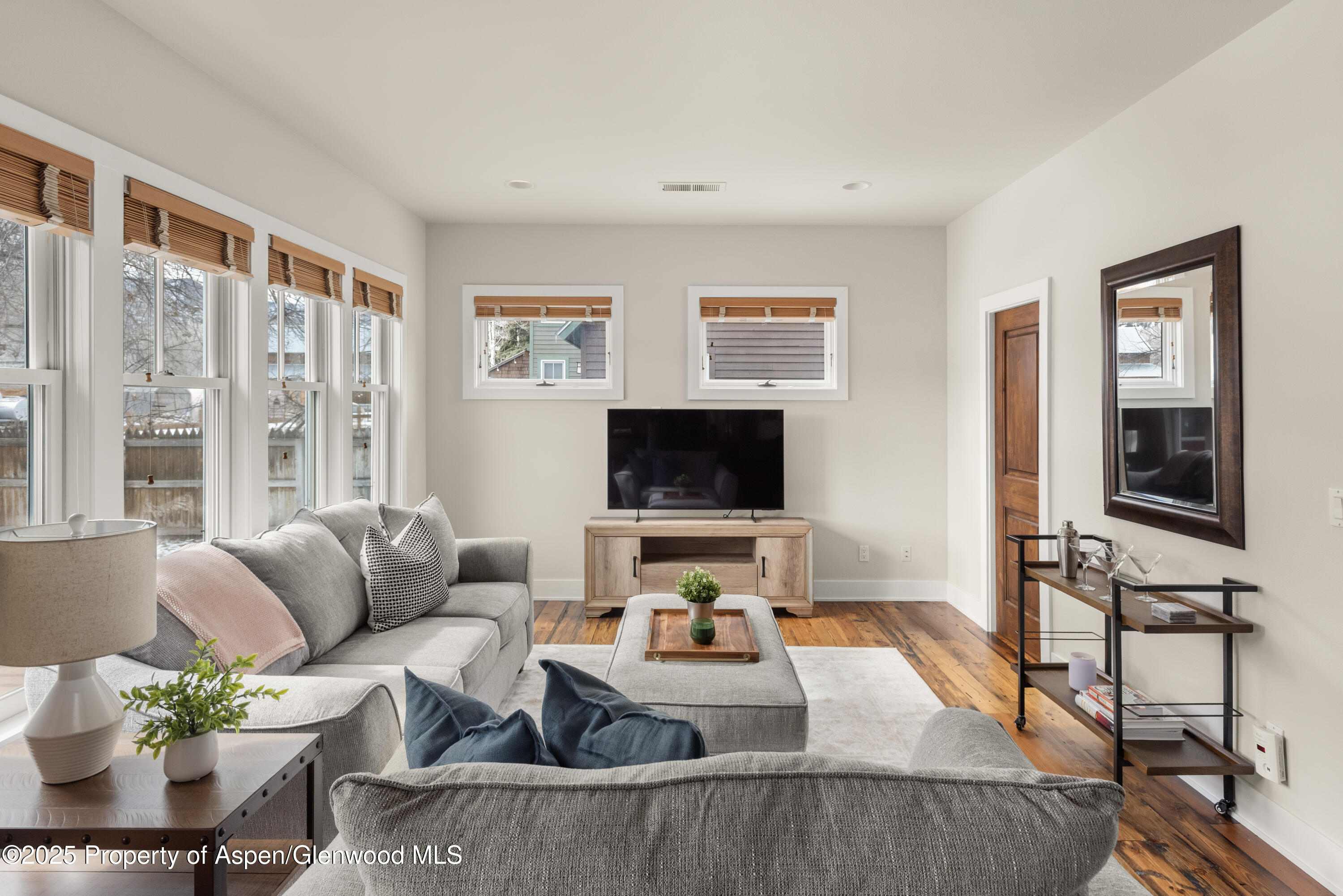 314 Sopris Circle Basalt, CO 81621 - Photo 11 of 36 a living room with furniture flat screen tv and a large window