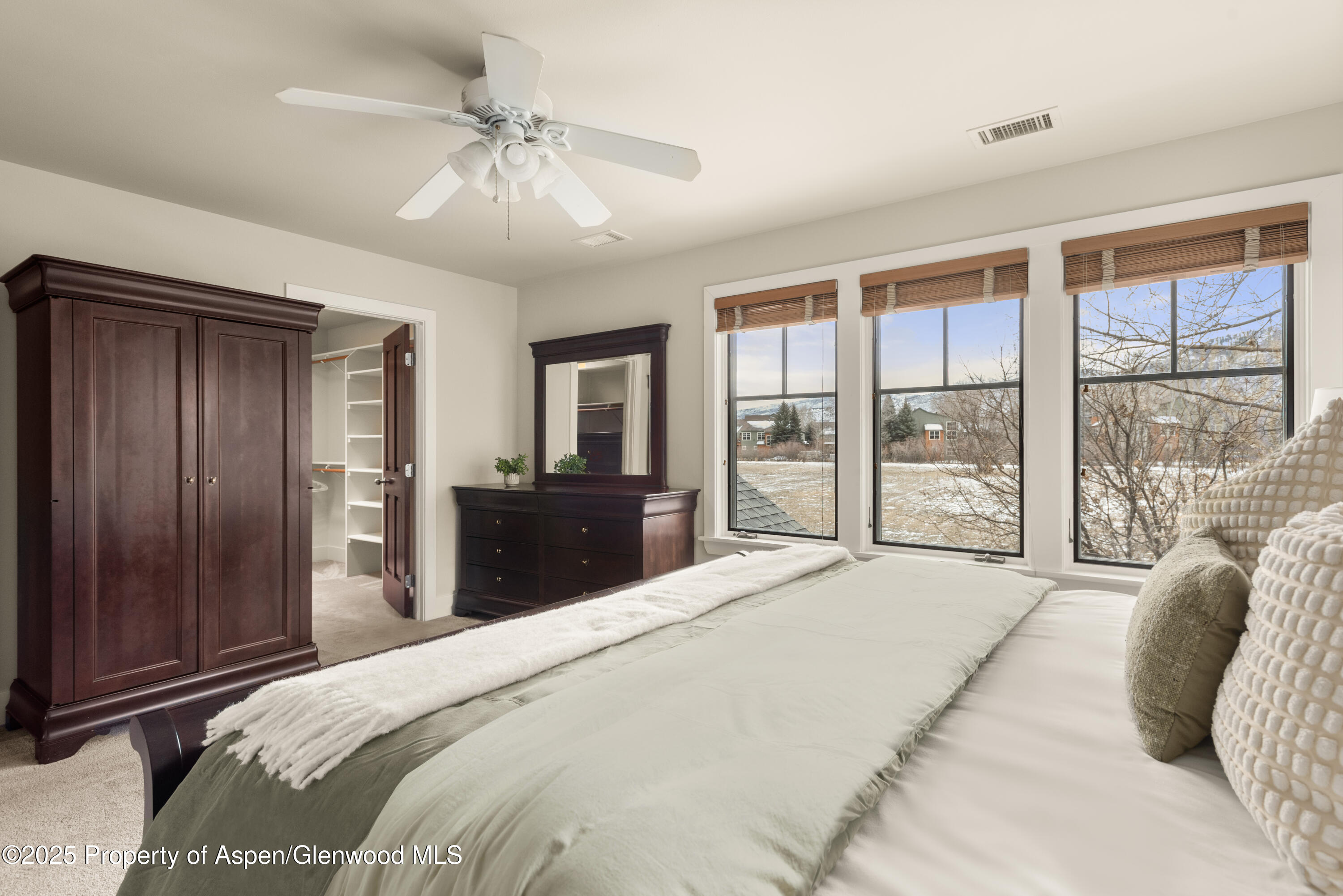 314 Sopris Circle Basalt, CO 81621 - Photo 18 of 36 a bedroom with a large bed and a chandelier fan