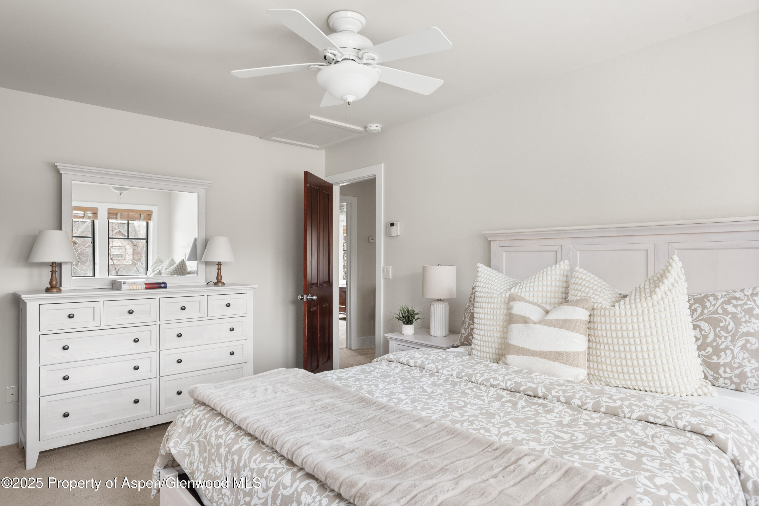 314 Sopris Circle Basalt, CO 81621 - Photo 21 of 36 a bedroom with a bed and a chandelier