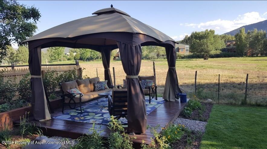 314 Sopris Circle Basalt, CO 81621 - Photo 29 of 36 a view of a patio with lawn chairs floor to ceiling window and wooden floor
