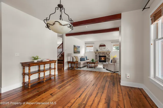 a very nice looking living room with wooden floor and furniture