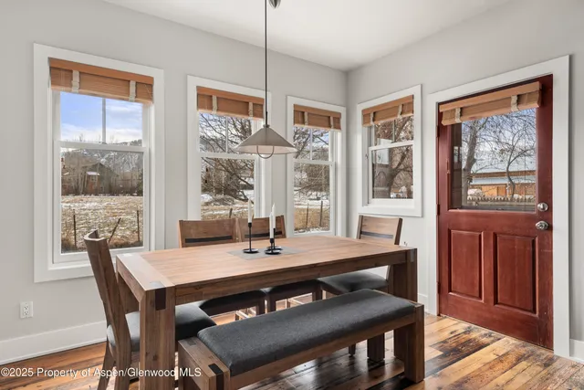 a view of a dining room with furniture window and wooden floor