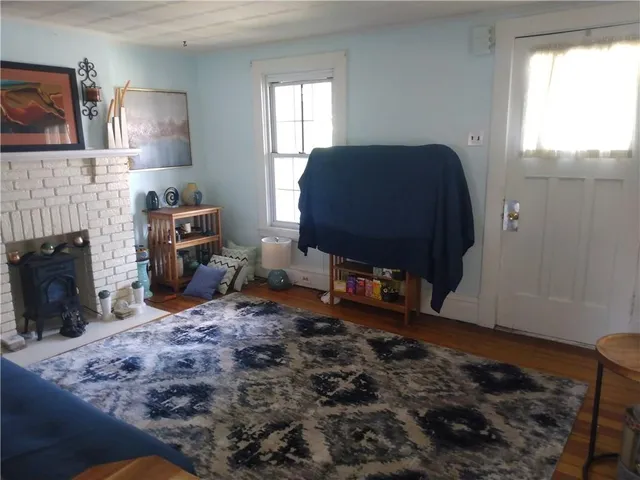 a living room with furniture window and a fireplace