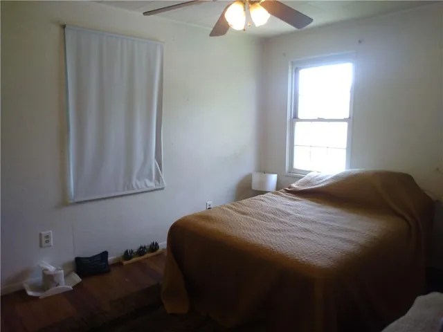 a bedroom with a bed and a window