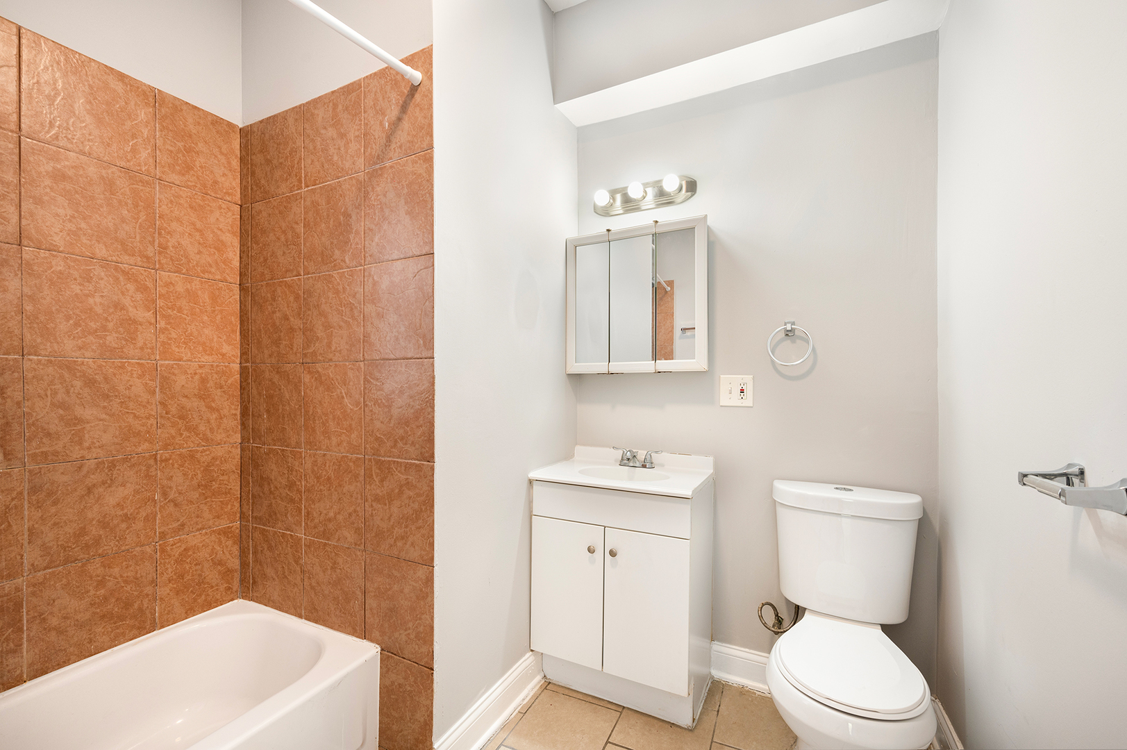 2437 East 74th Street, Unit 3W Chicago, IL 60649 - Photo 13 of 18 a bathroom with a sink a toilet and shower
