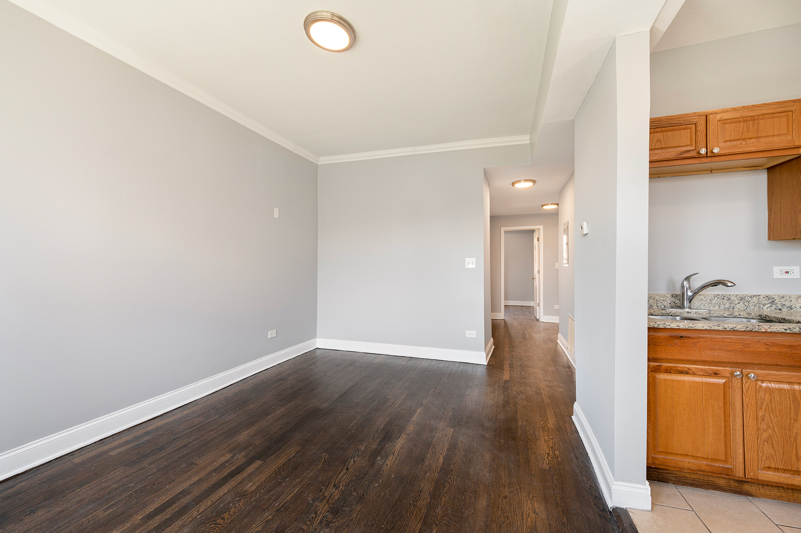 2437 East 74th Street, Unit 3W Chicago, IL 60649 - Photo 4 of 18 a view of a hallway and wooden floor