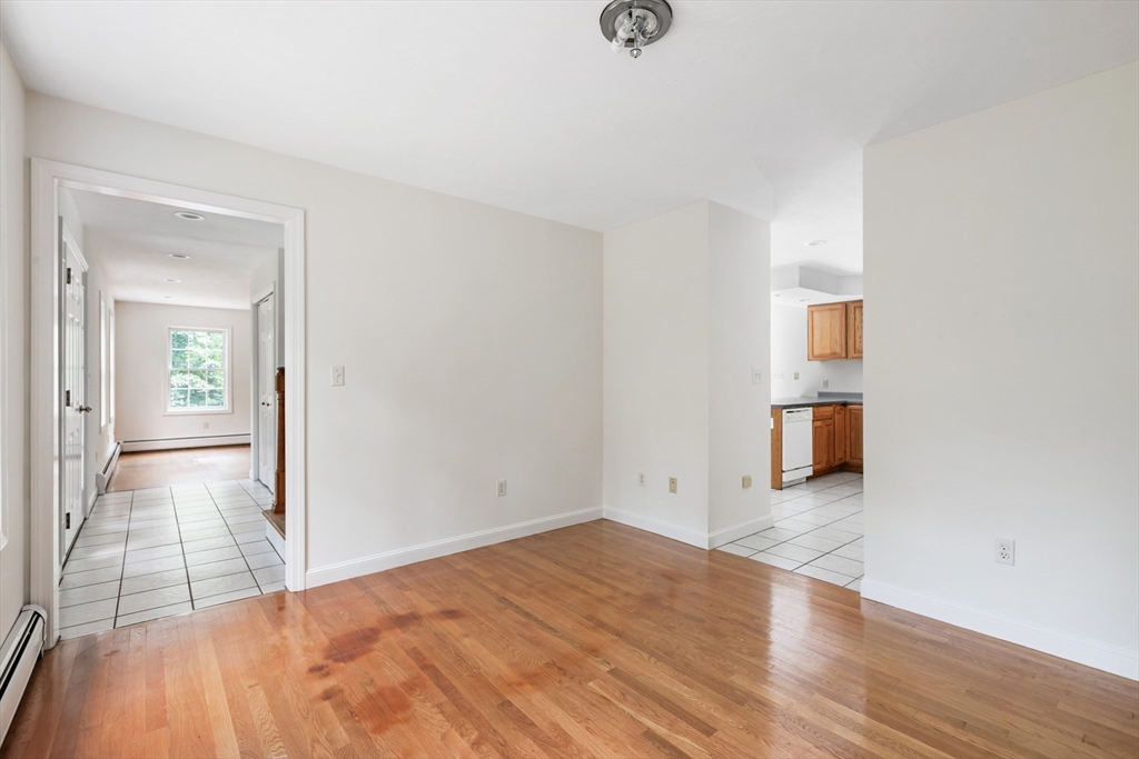 341 Quaddick Road Thompson, CT 06277 - Photo 10 of 29 an empty room with wooden floor and mirror